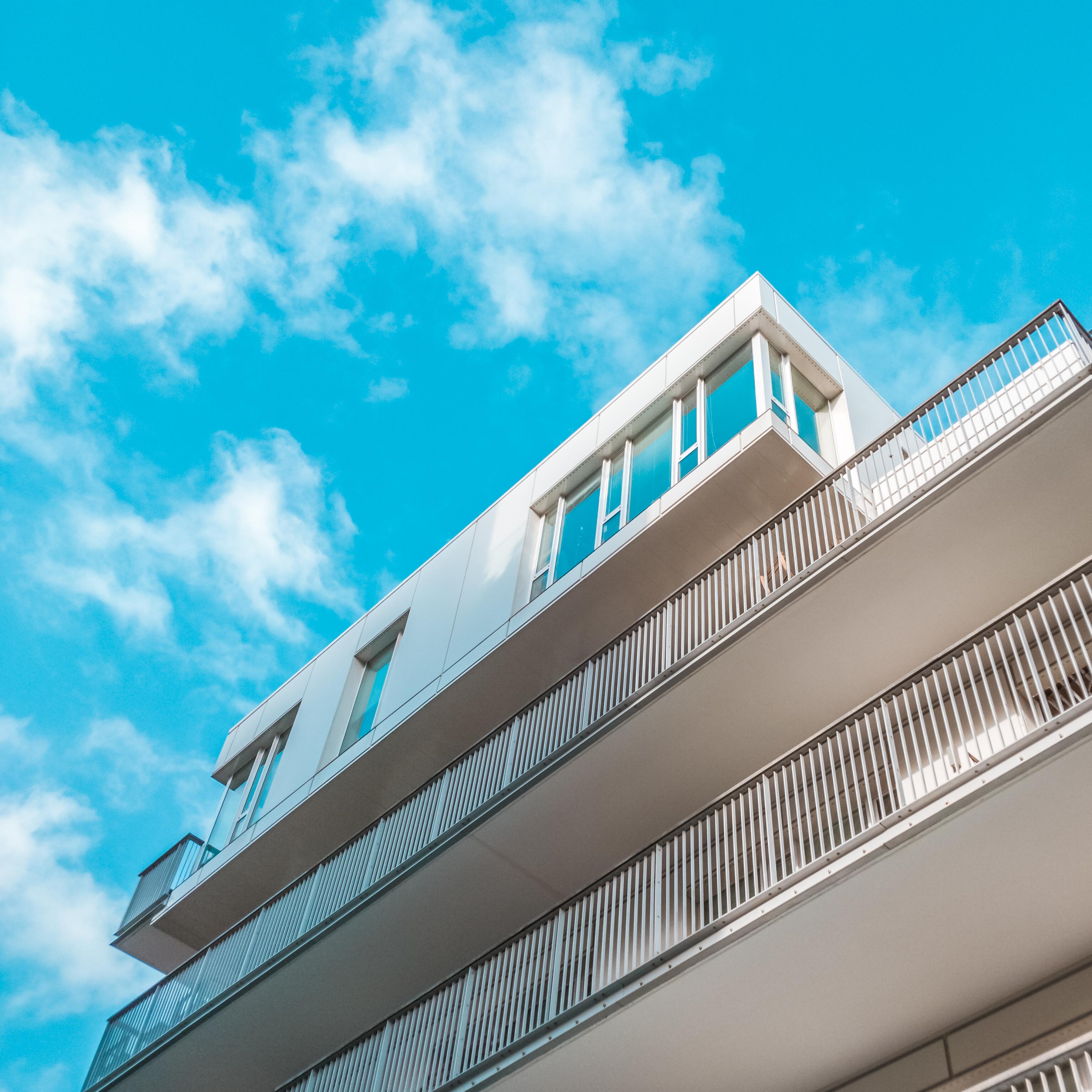 White building with balconies against blue sky